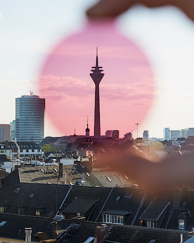 Mann in Jeansjacke trägt stylische Brille in Düsseldorf